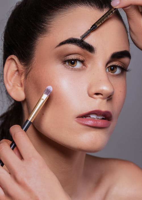 Close-up Portrait of Woman Getting Her Makeup Done 