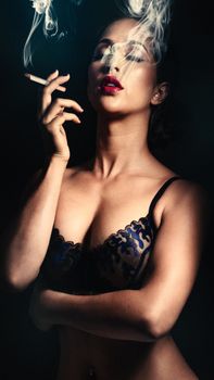A captivating portrait of a woman smoking, exuding allure and confidence.