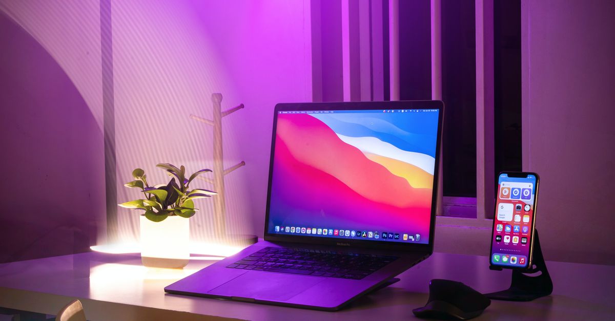 Computer Phone Image A Laptop and a Cellphone over a Wooden Desk · Free Stock Photo