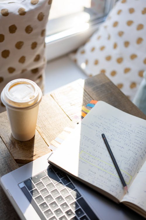 Top View of a Notebook and Coffee on the Table