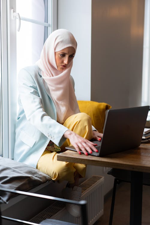 Woman Wearing Hijab Using Macbook