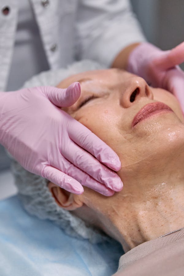 Senior woman receiving spa facial treatment for rejuvenation