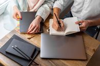 Person in White Dress Shirt Writing on White Paper