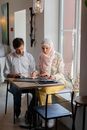 Man and Woman Sitting at Table
