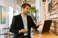Man in Black Suit Jacket Using Black Laptop Computer