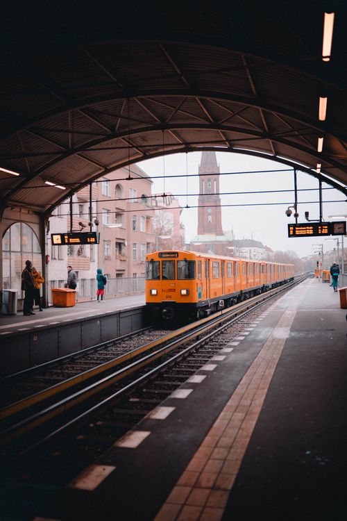 Free Vibrant yellow metro train arrives at a Berlin station, showcasing urban transit. Stock Photo