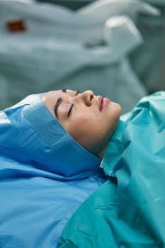 Close-up image of a woman sedated during a surgical procedure in an operating room.