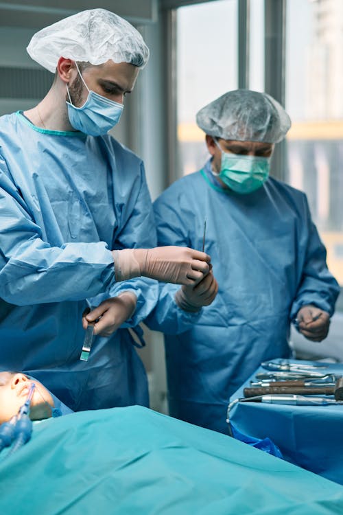 Male Surgeons in an Operating Room Performing a Surgery 