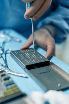 A close-up of a piezoelectric surgical tool performing a delicate incision.