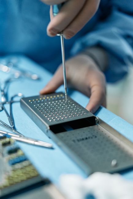 A close-up of a piezoelectric surgical tool performing a delicate incision.