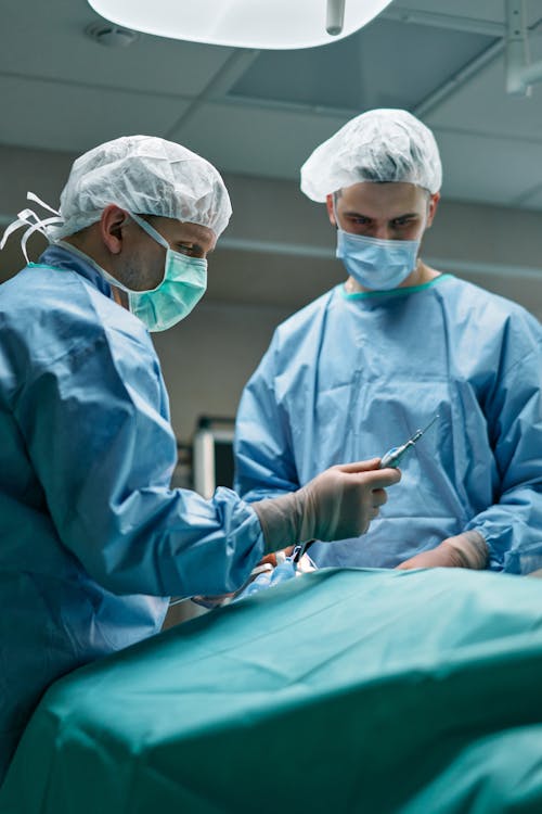 Men Wearing Personal Protective Equipment Standing in a Room