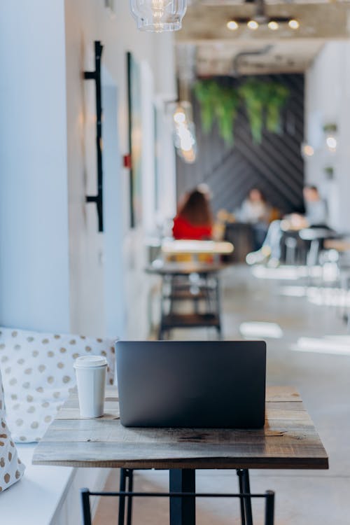 Black Laptop Computer on Table next to a Beverage