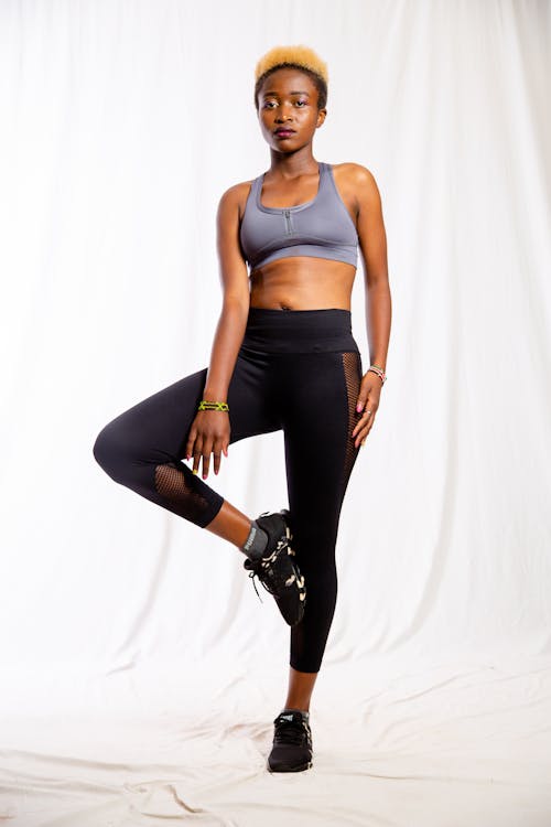 Free Photo of a Woman Wearing a Gray Sports Bra and Black Leggings Stock Photo