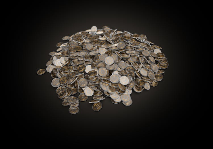 A Pile Of Silver And Gold Coins