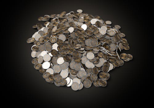 Free Silver Round Coins on Black Surface Stock Photo