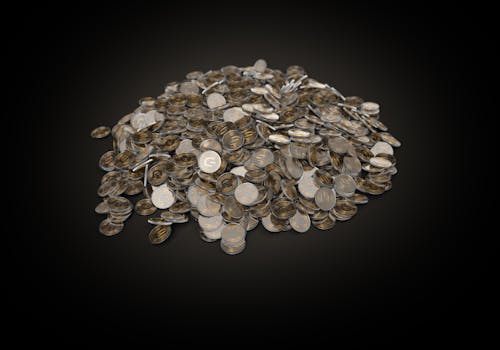 Free A Pile of Coins on a Black Surface Stock Photo