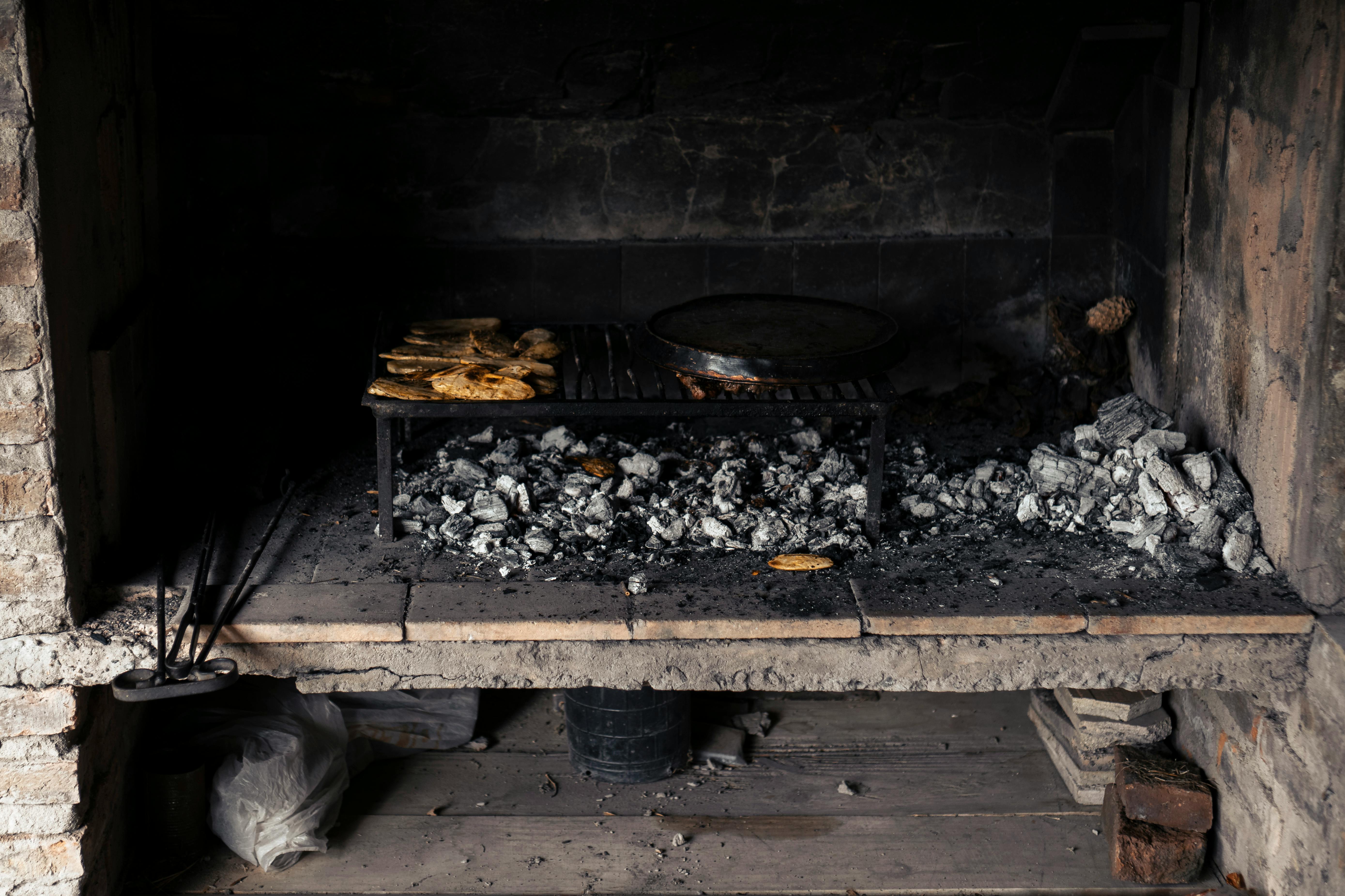 Thick-sliced rustic bread being grilled over an open flame - classic bruschetta recipe