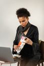 Woman in Black Blazer Holding Orange and White Plastic Bottle