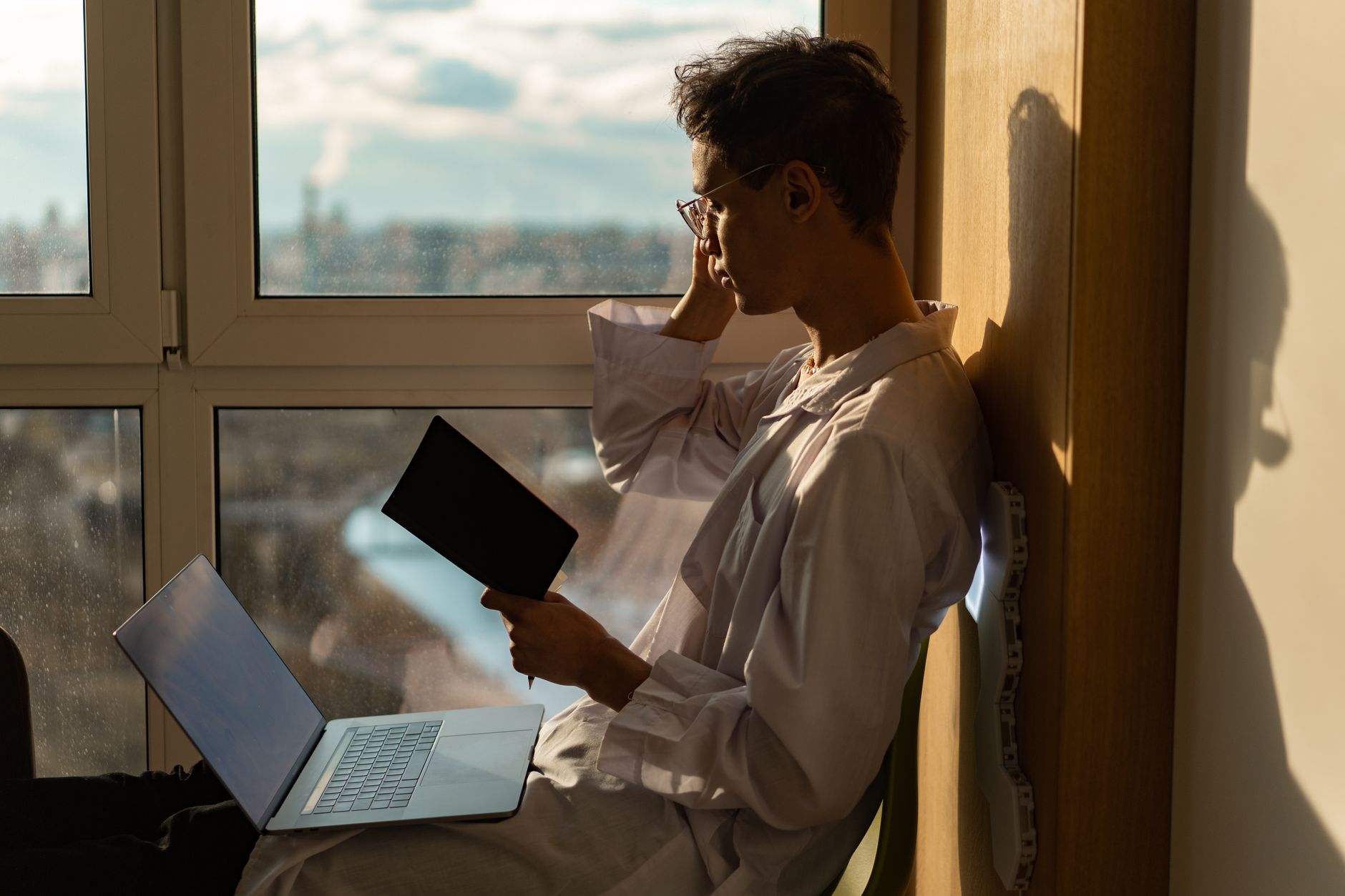 ADHD task paralysis focus & productivity adhd — woman sitting at messy desk overwhelmed papers everywhere warm lamp light
