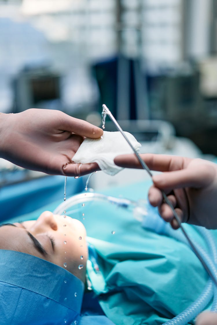 Person Holding Silver Medical Tool