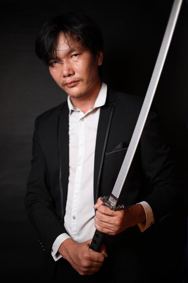 Confident Japanese Man With Katana In Formal Outfit