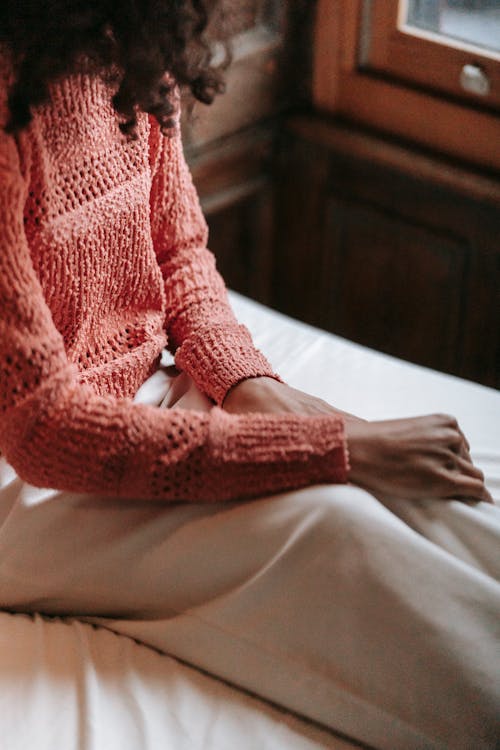 Free Black woman sitting near window in solitude Stock Photo