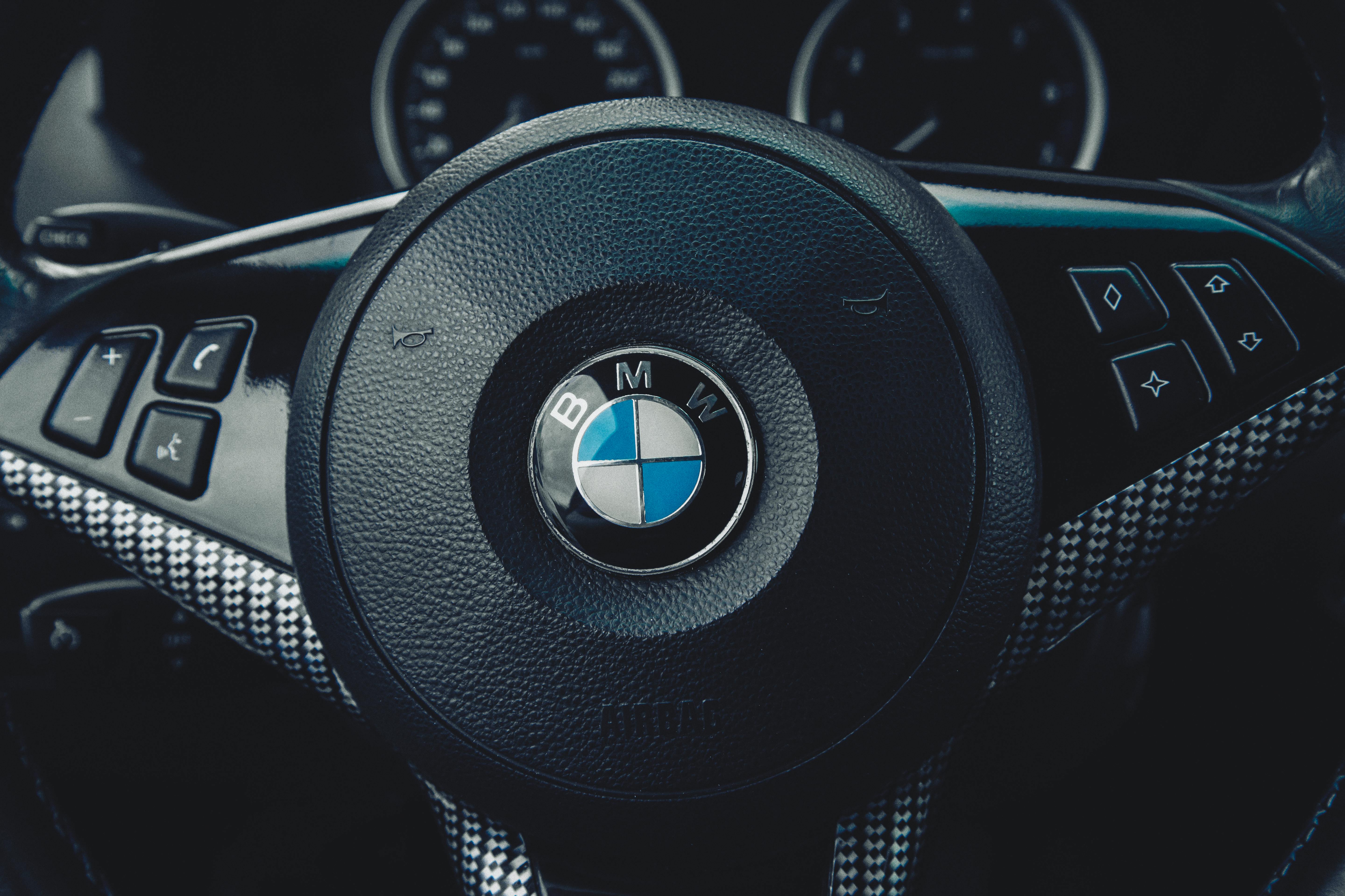 Close-up Photo of the BMW Emblem on Steering Wheel · Free Stock Photo