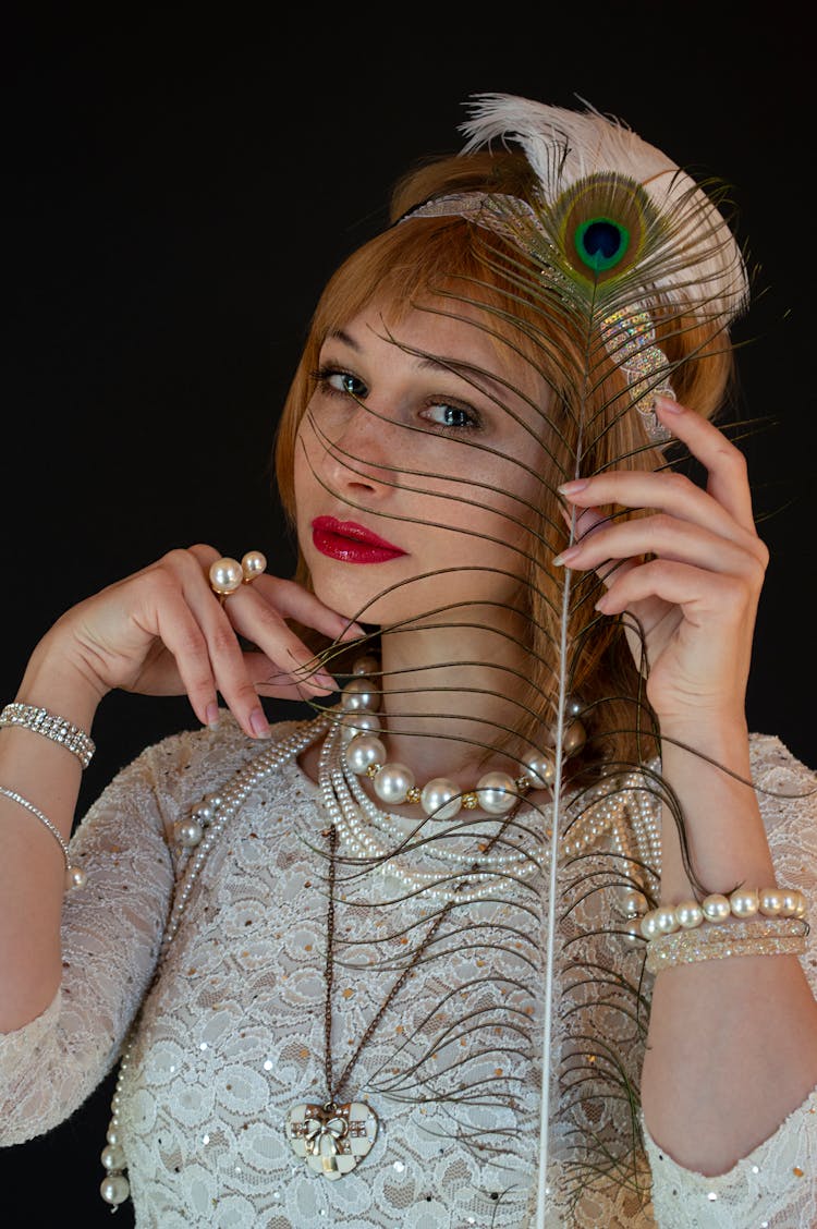 Woman In Vintage Wear With Peacock Feather