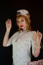 Fashionable woman in vintage dress with headpiece