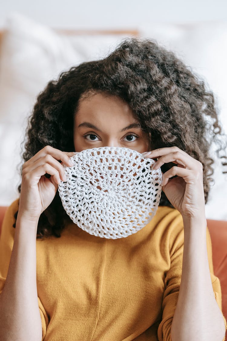 A Woman Holding A Doily