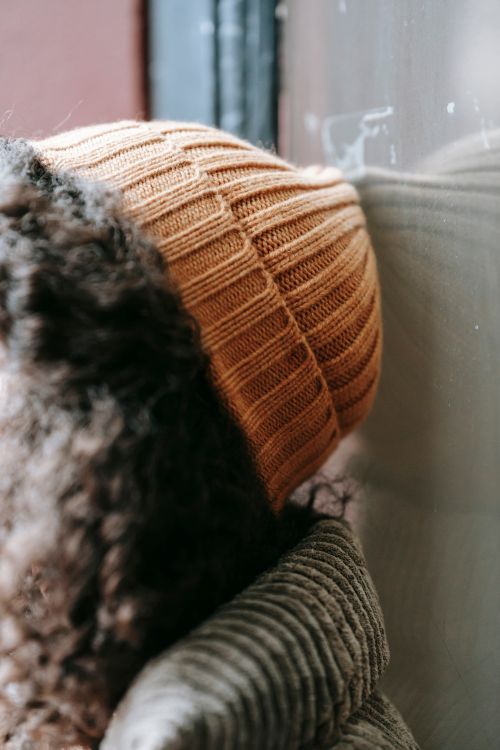 Free Close-up of a woman in a knit hat with curly hair during winter. Warm and fashionable attire. Stock Photo