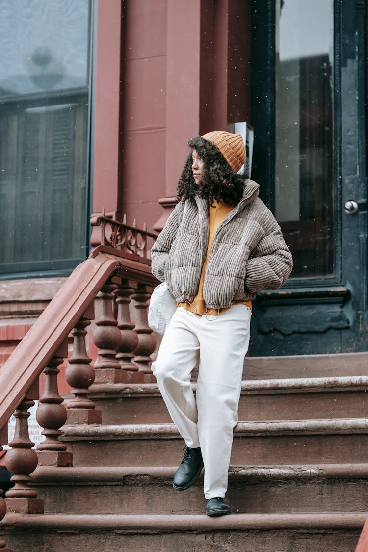 Stylish Black Woman Walking On Stairs In Town