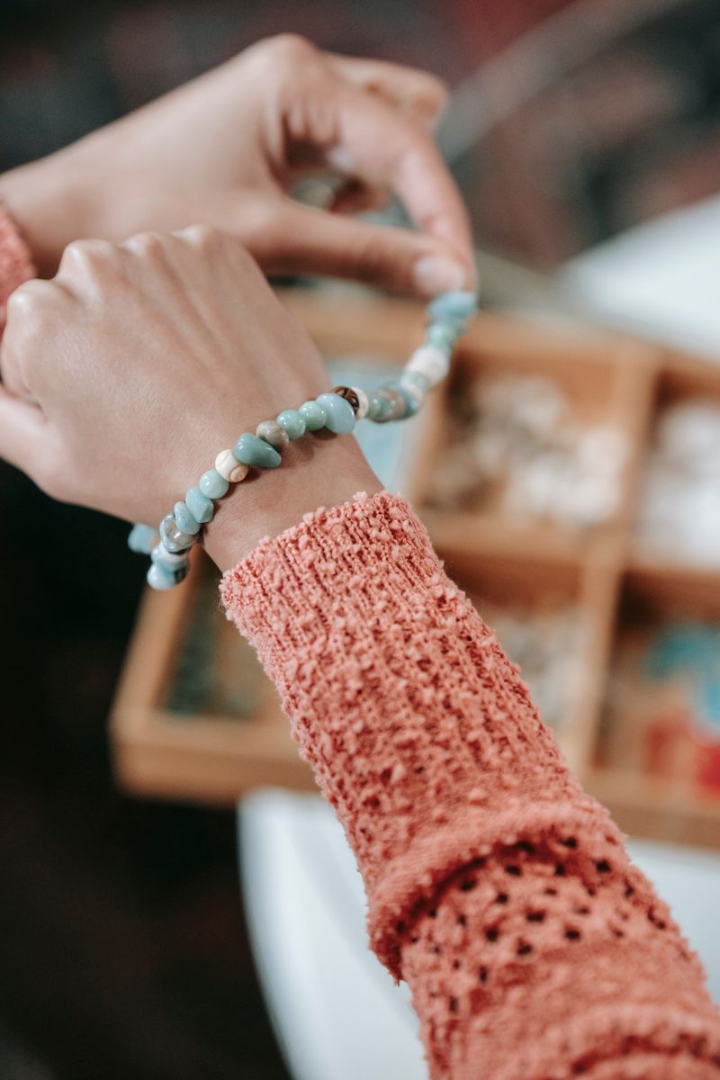 Trying on a handmade beaded bracelet, reference style