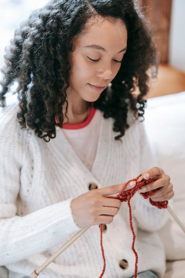 Black Woman Knitting On Couch