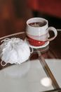 Yarn and cup of tea on table in house