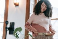 Delighted woman demonstrating skirt and making photo on mobile phone