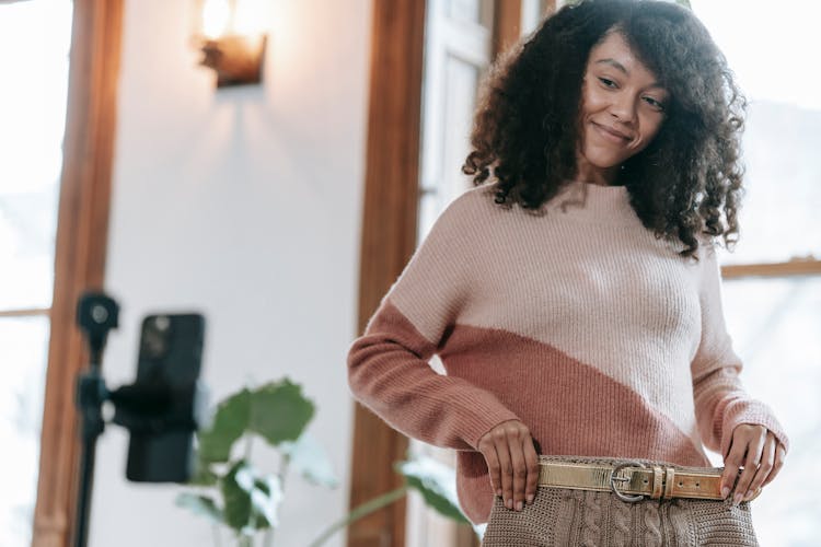 Delighted Woman Demonstrating Skirt And Making Photo On Mobile Phone