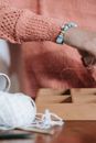 Faceless woman putting items into wooden box for craftwork