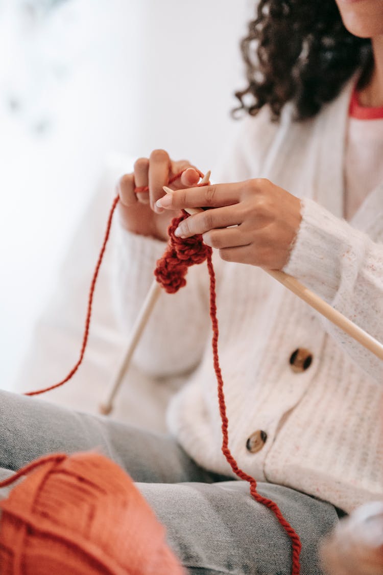 Woman Knitting With Woolen Yarn And Needles