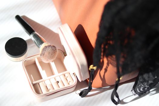 Close-up of a jewelry box and makeup brush set elegantly arranged, perfect for fashion and lifestyle context.
