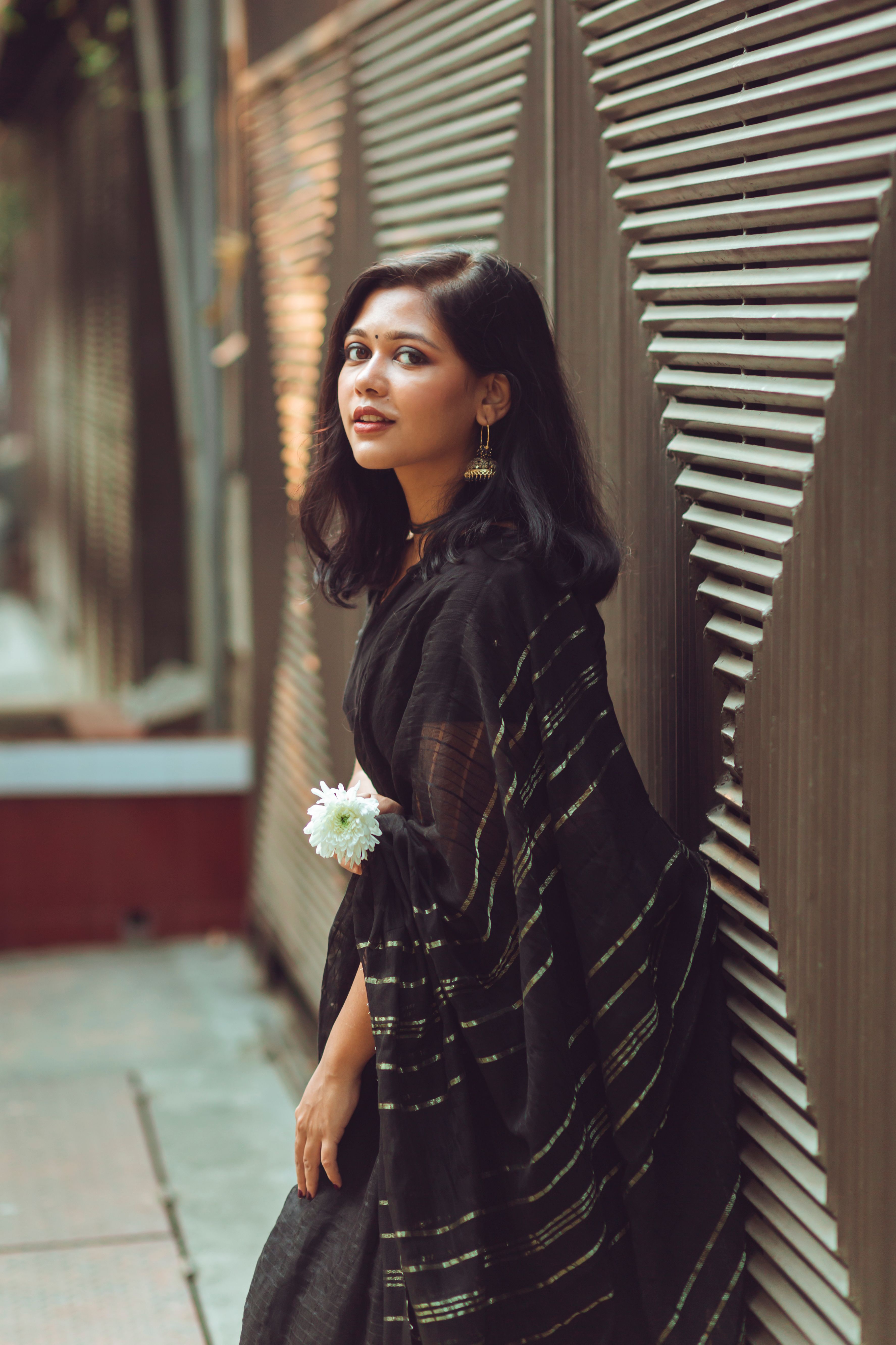 A Beautiful Woman in a Black Dress Leaning on a Patterned Wall · Free ...