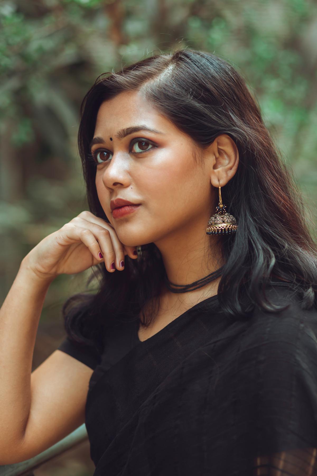 Person looking out window from a shaded room during a sunny day