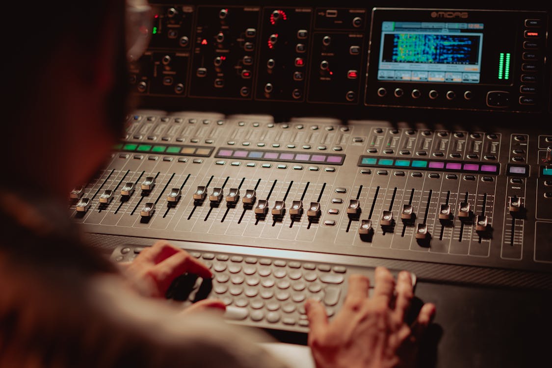 A Person Working with an Audio Mixer · Free Stock Photo