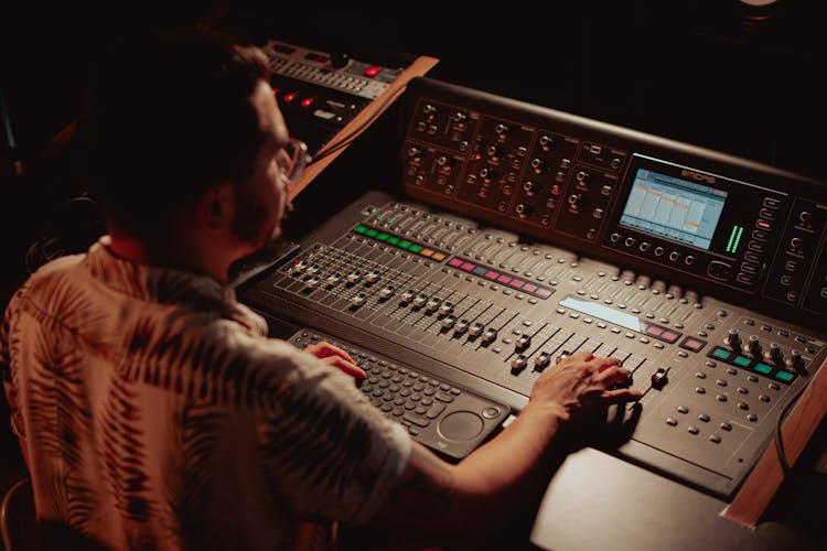 An Audio Engineer Working With A Console