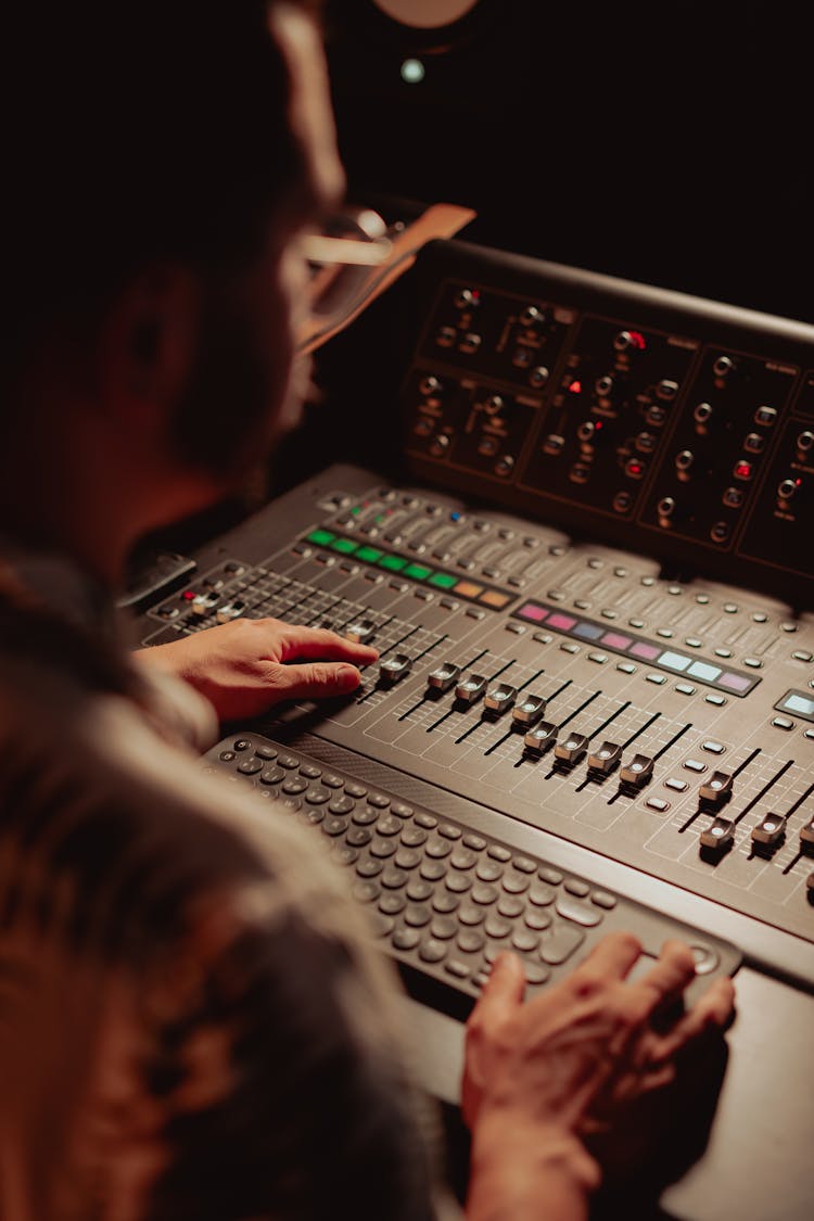 A Sound Engineer Using An Audio Mixer