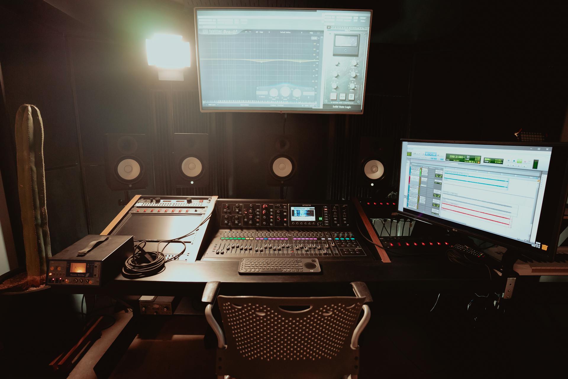 Professional recording studio featuring audio mix console and monitors for music production.