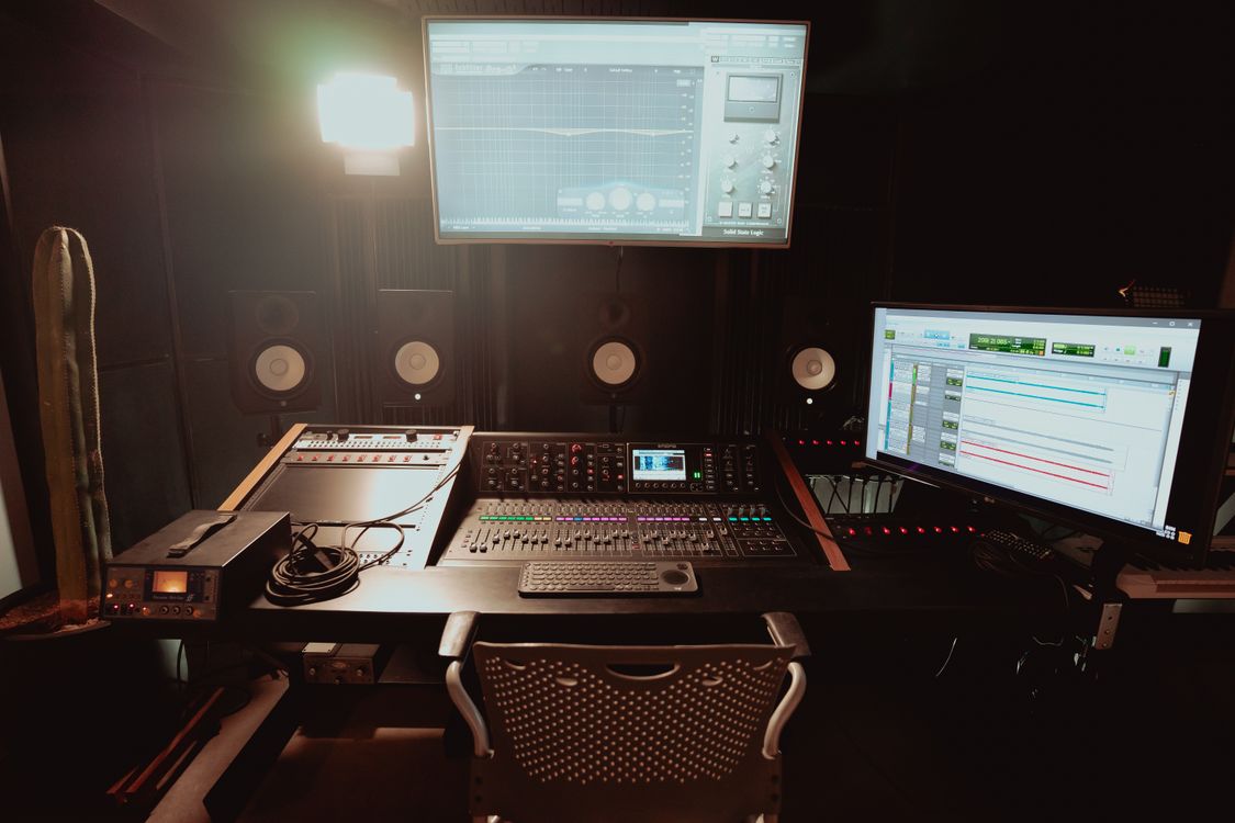 A professional recording studio with mixing equipment and monitors used to prepare music for audiovisual licensing