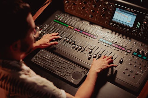 An Audio Engineer Controlling the Audio Mixer