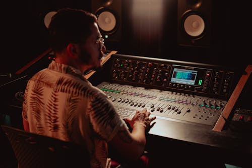 A Man Using an Audio Mixer