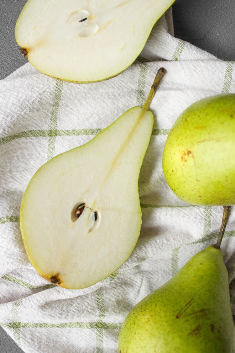 Pieces Of Green Pears On Tablecloth